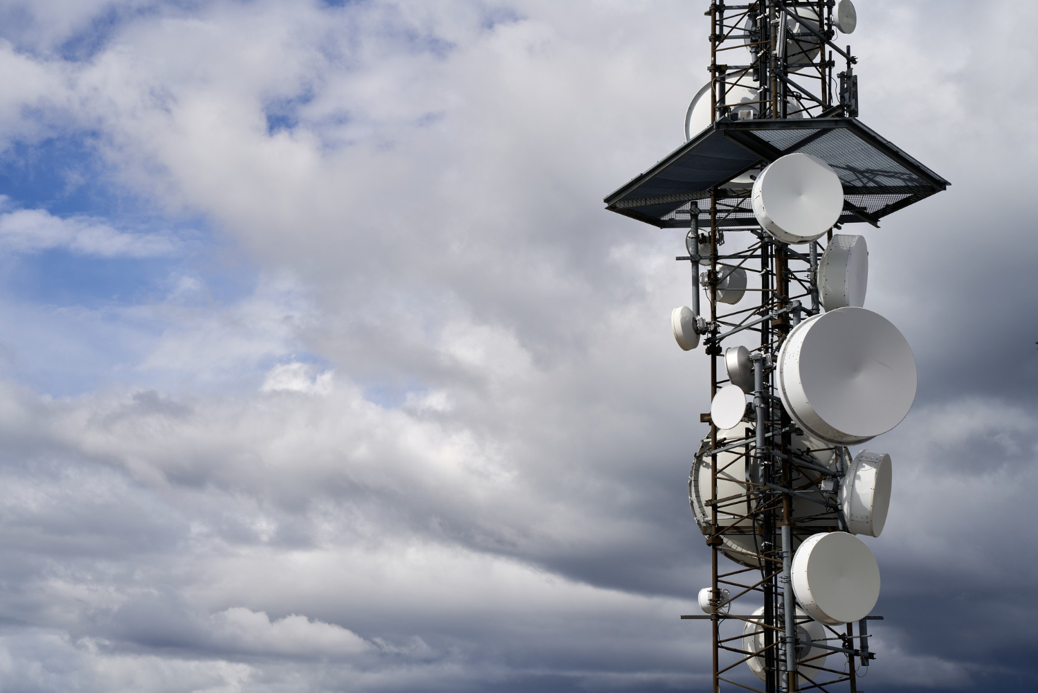 telecommunications-towers-against-cloudy-sky